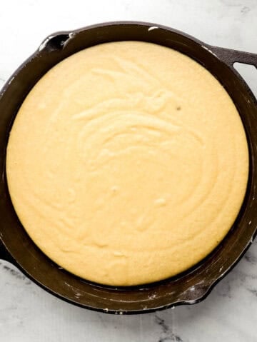 Cornbread mixture added to cast iron skillet.