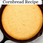 Overhead view of honey butter cornbread in cast iron skillet on pin with text overlay.