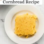 Piece of cornbread on small white plate on pin with text overlay.
