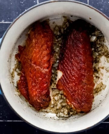 Meat added to dutch oven with onion mixture.
