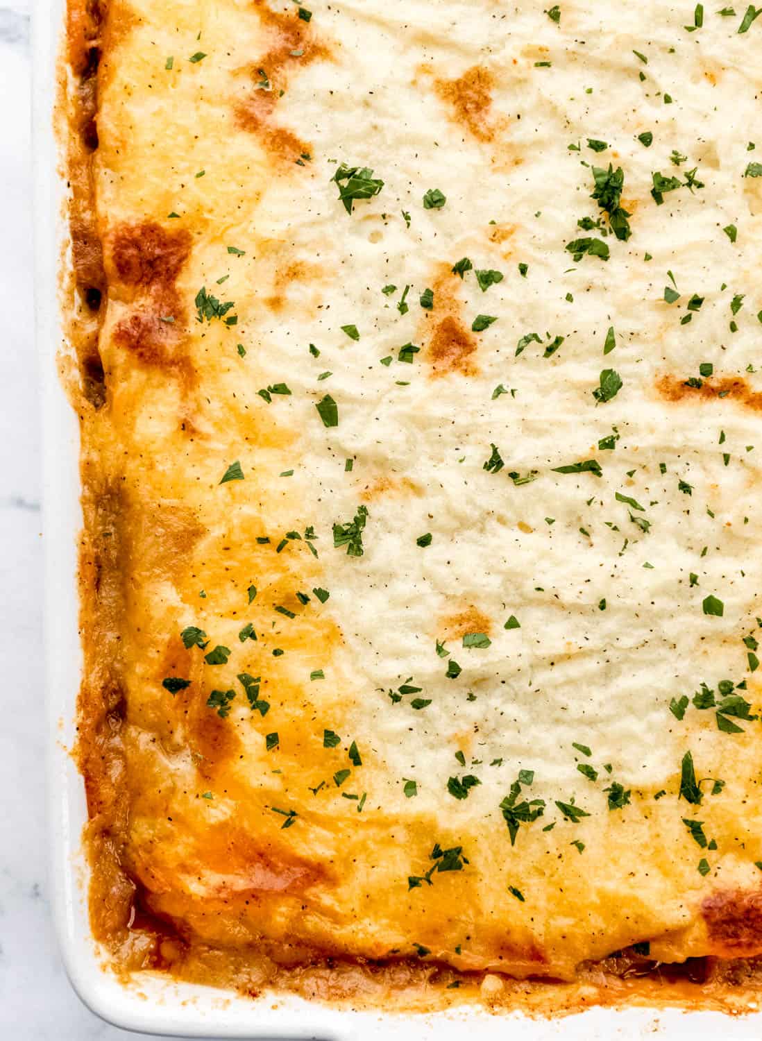 Overhead view of finished shepherd's pie topped with chopped parsley.