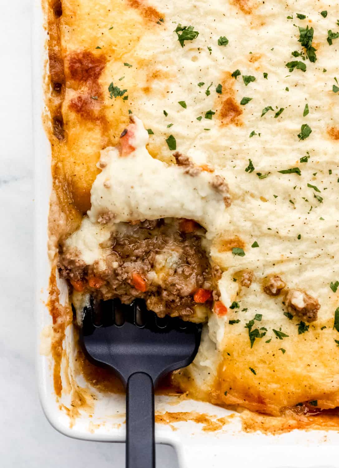 Finished shepherd's pie with spatula in it. 