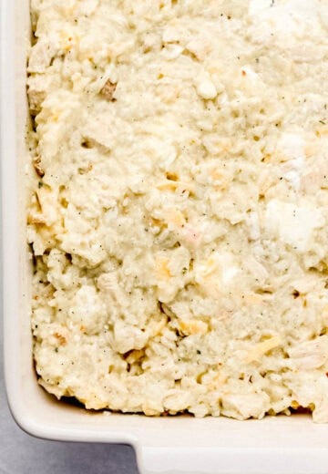 Casserole ingredients added to rectangle shaped baking dish.