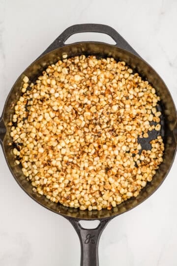 Overhead view of corn in cast iron skillet.
