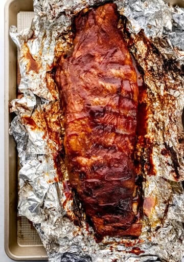 Overhead view of finished ribs on top of foil on sheet pan.