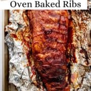 Overhead view of finished ribs on top of foil and sheet pan on pin with text overlay.