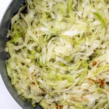 Overhead view of finished cabbage in large skillet.