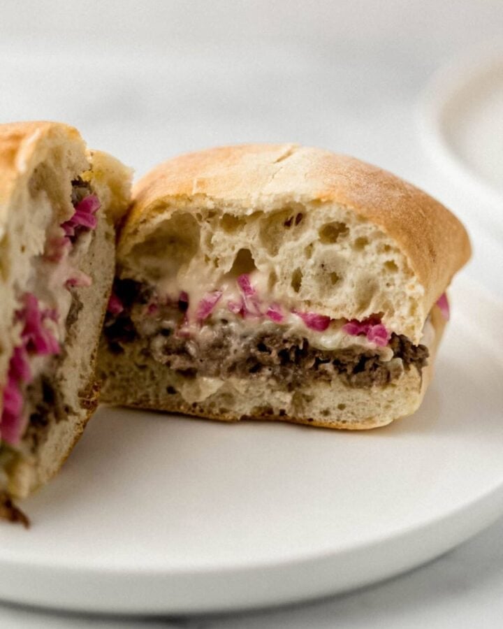 Close up center of finished sandwich on white plate. 