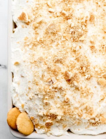 Overhead view of finished tres leches cake in white baking dish.