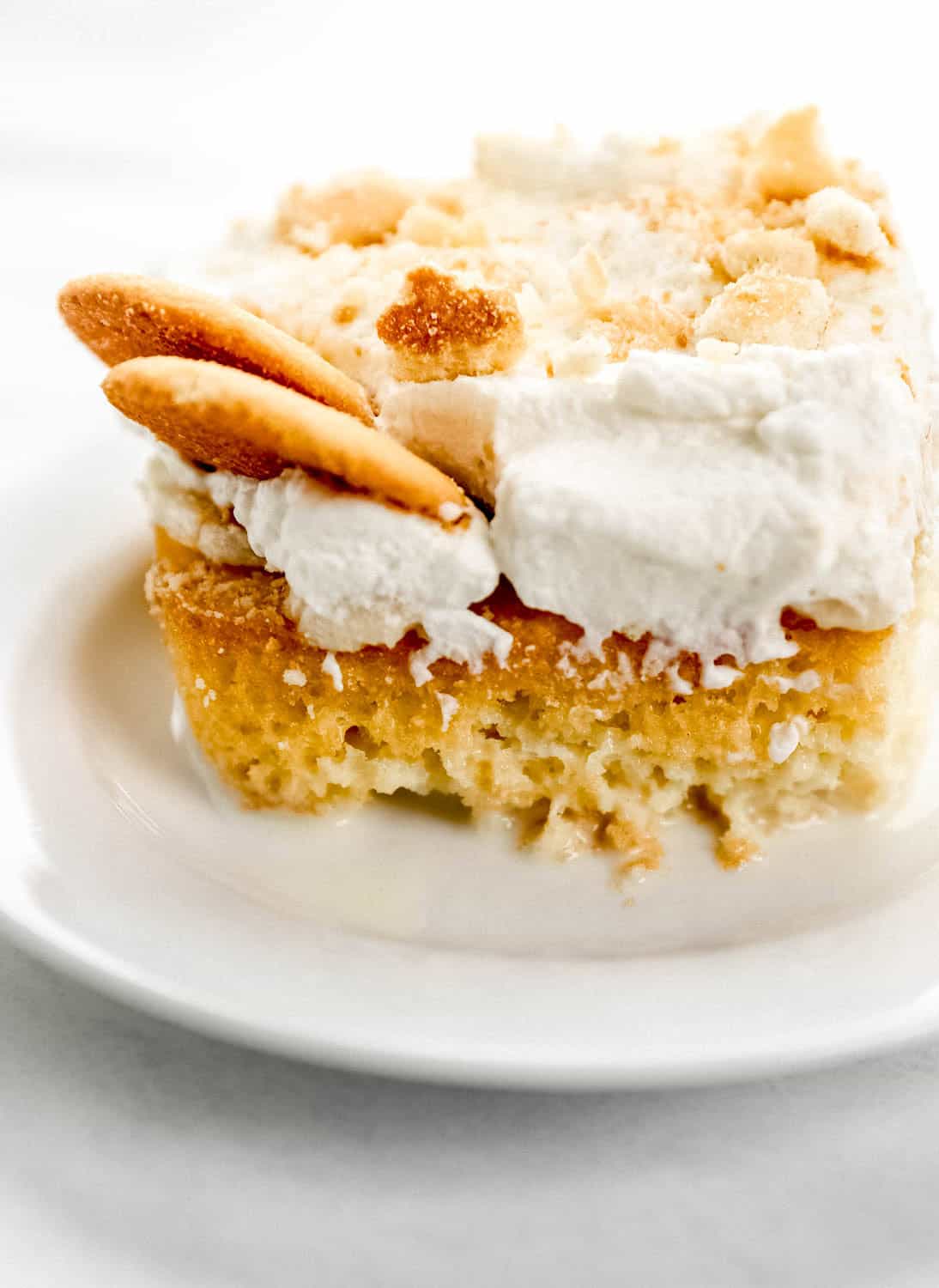 Close up side view of piece of cake on white plate.
