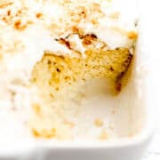 Close up view of finished cake in baking dish with some of it taken out of it.