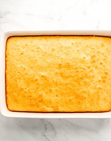 Baked cake in white rectangle baking dish.