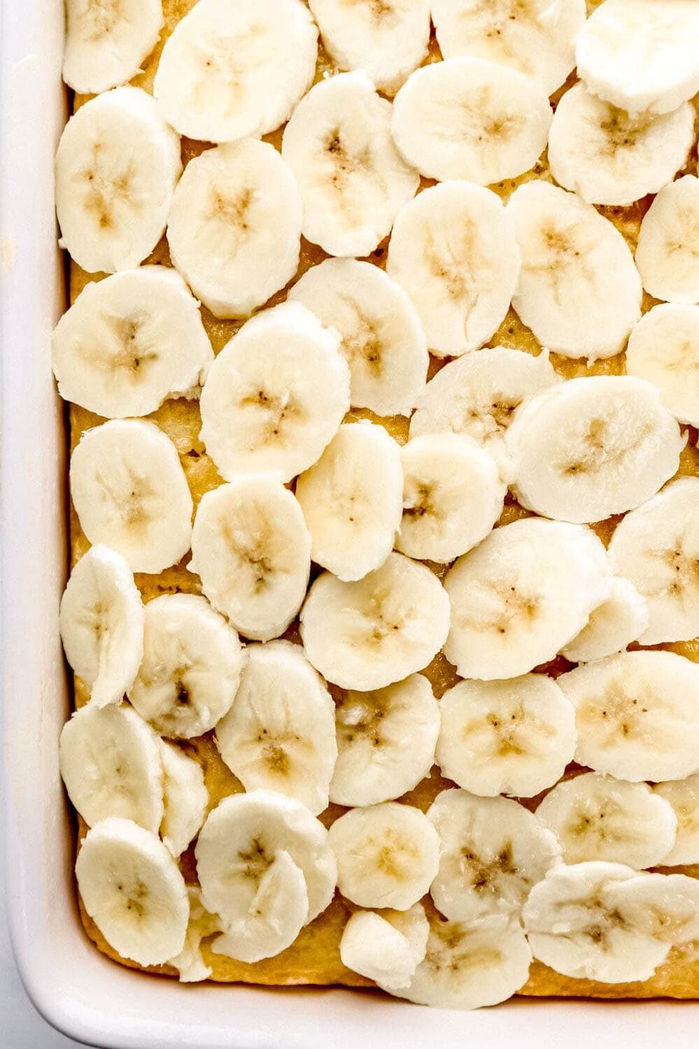 Overhead view of cake topped with banana slices.