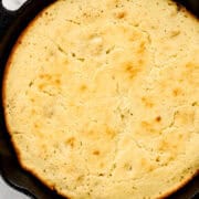 Close up overhead view of finished cornbread in cast iron skillet.
