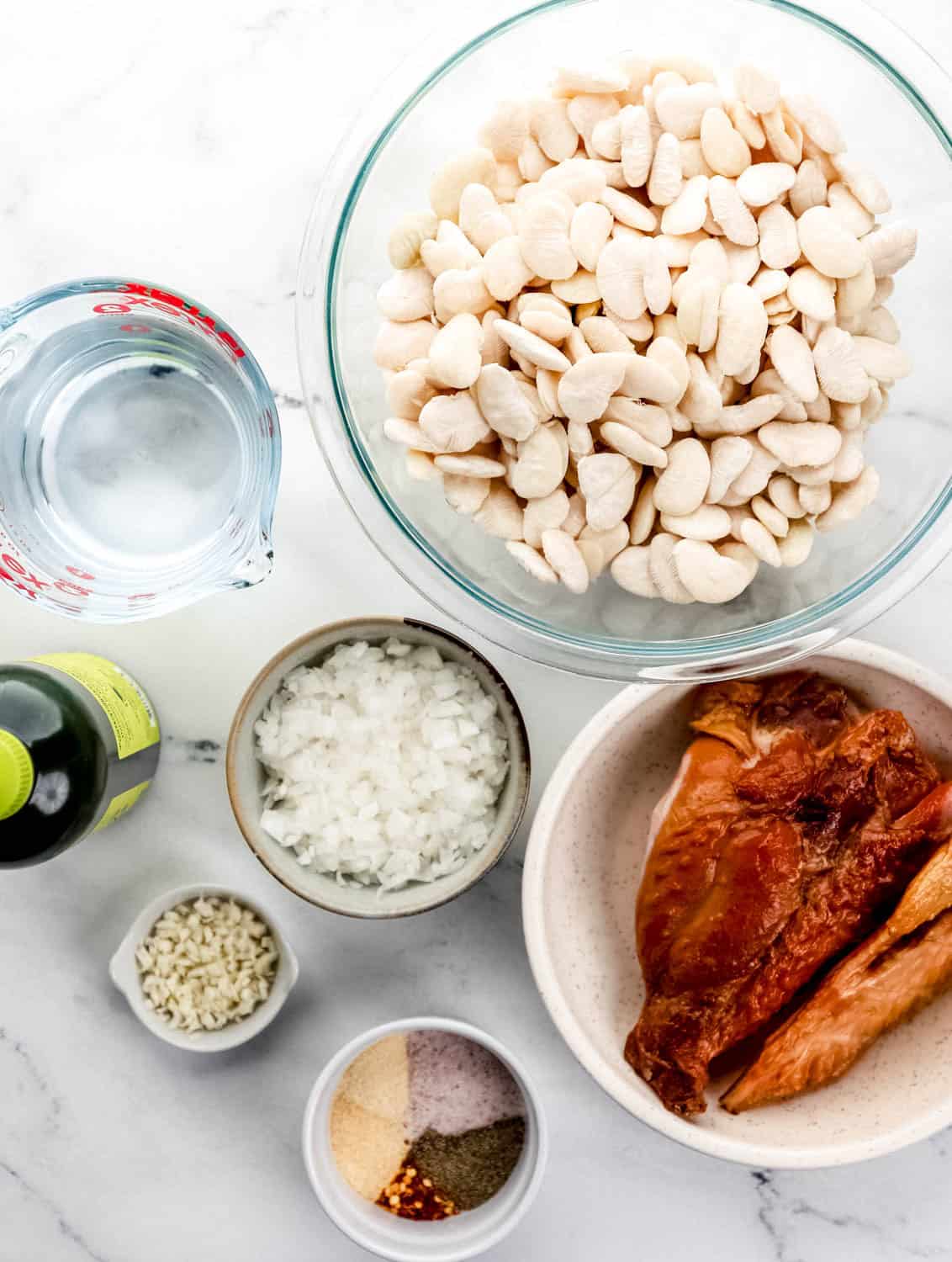 Overhead view of ingredients needed to make beans in separate bowls.