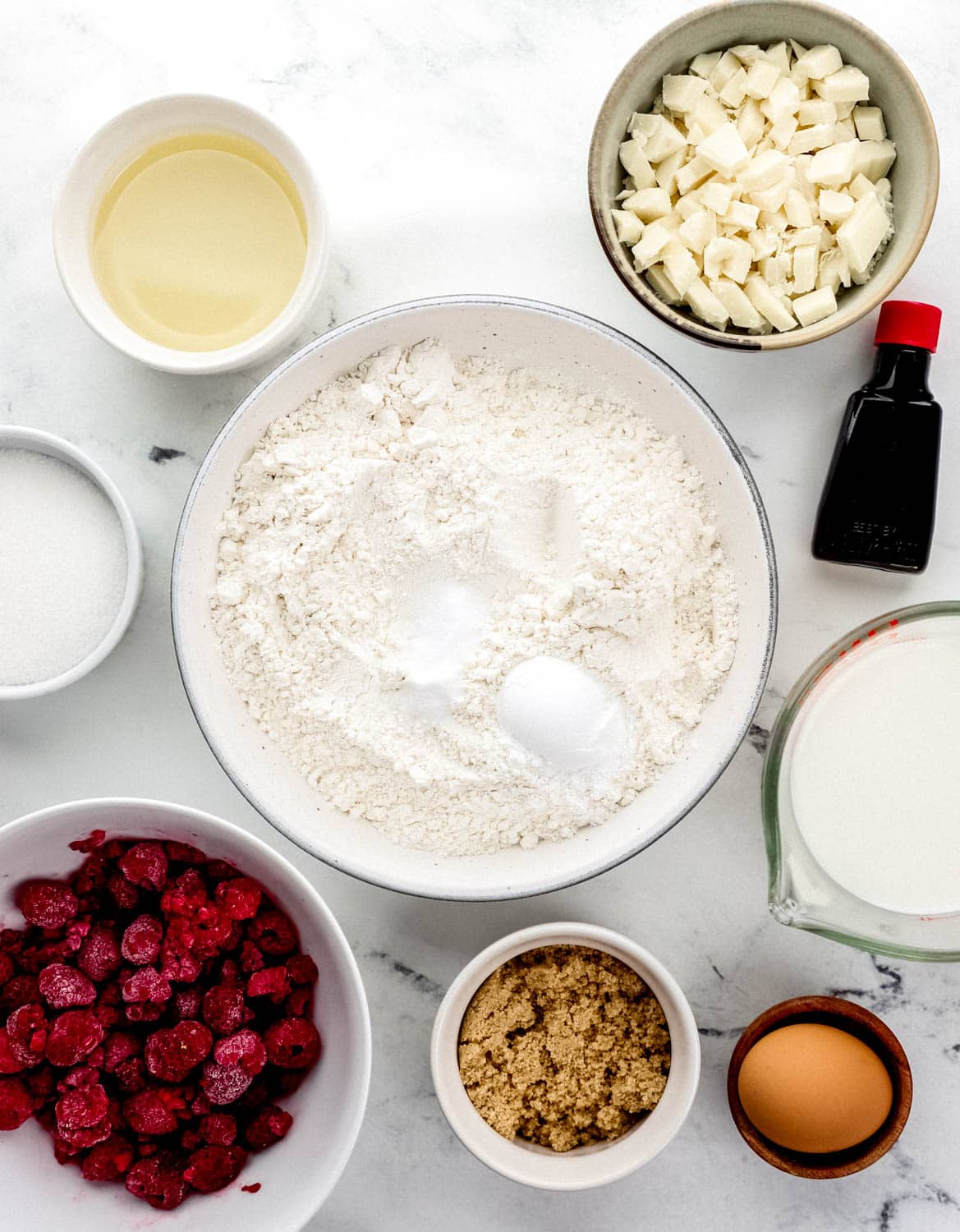 Overhead view of ingredients needed to make muffins in separate bowls.