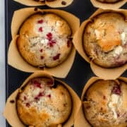 Overhead view of finished muffins in liners in muffin pan.