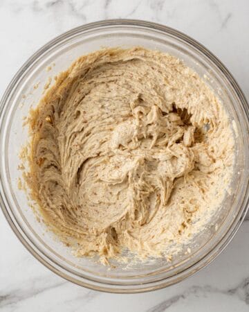 Cookie batter in large glass mixing bowl before scooping.