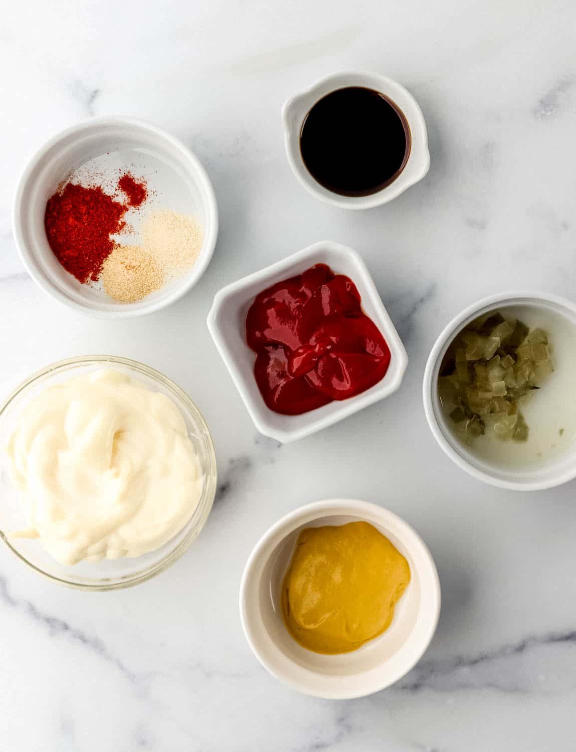 Overhead view of ingredients to make sauce in separate bowls. 