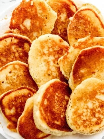 Overhead view of hoe cakes on paper towel lined plate.