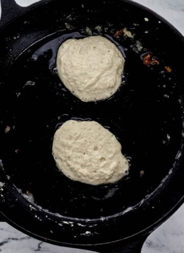 Batter added to cast iron skillet with hot oil and butter in it.
