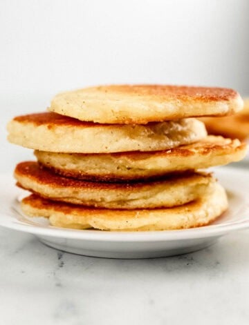 Close up side view of stack of cakes on plate.
