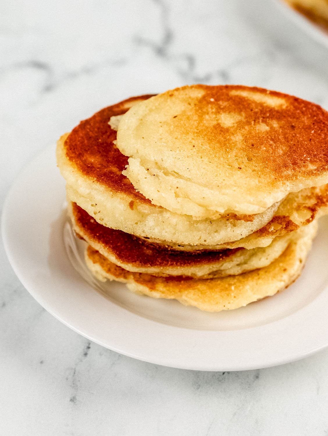 Stack of cakes on a small white plate. 
