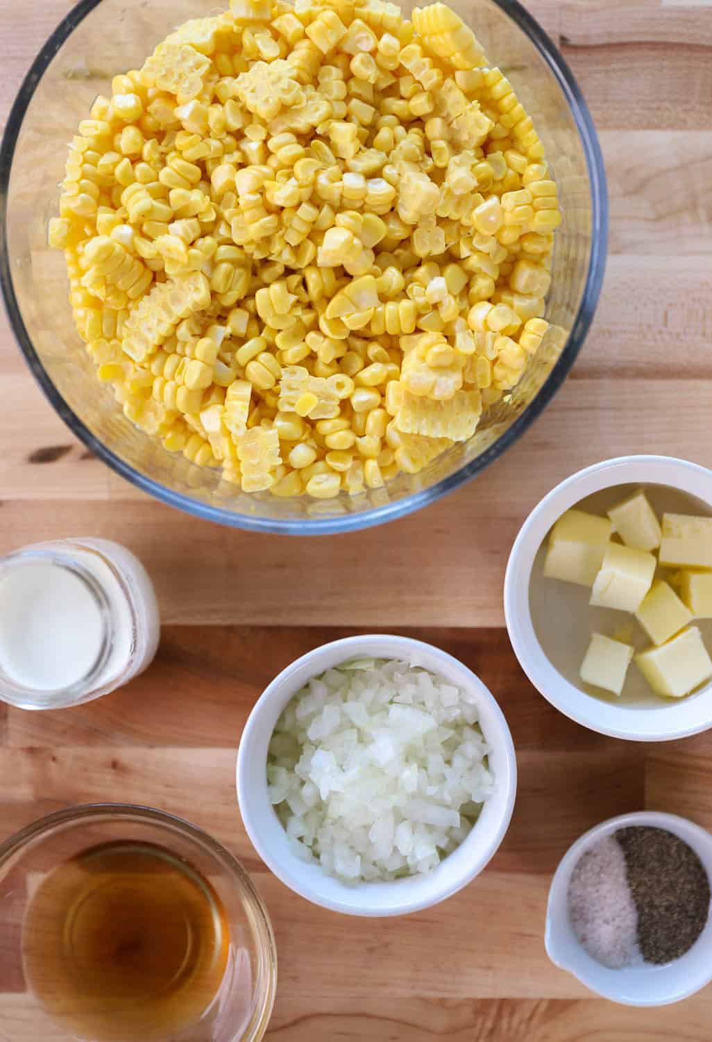 Overhead view of ingredients needed to make corn in separate bowls. 