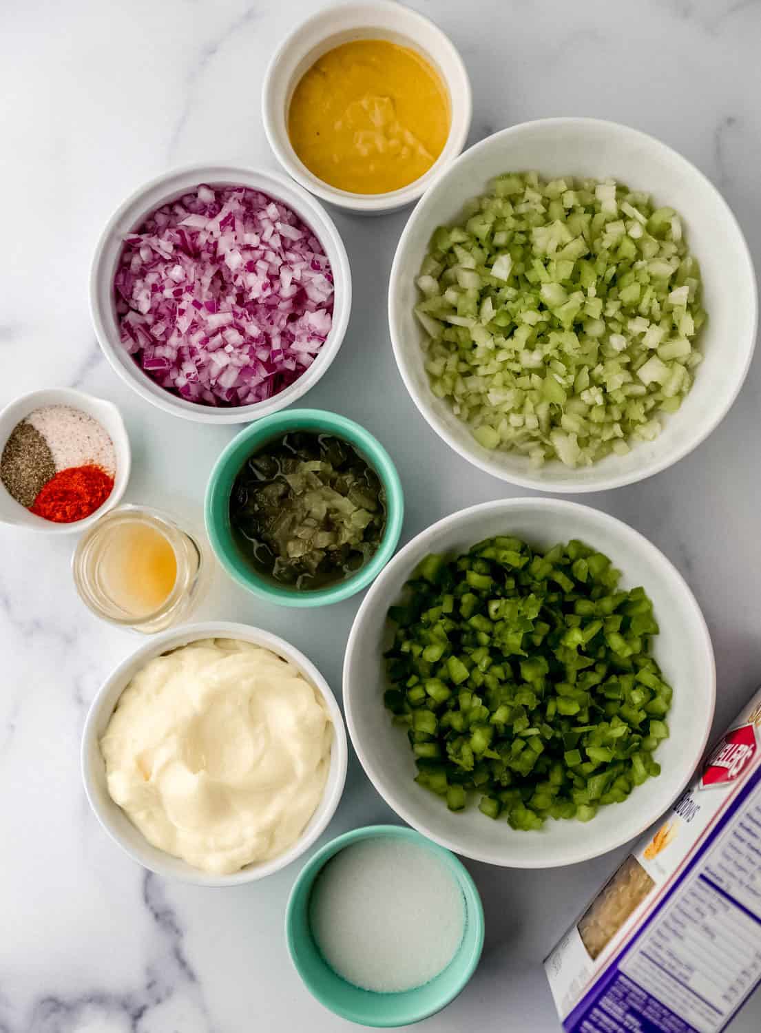 Overhead view of ingredients needed to make salad in separate bowls. 