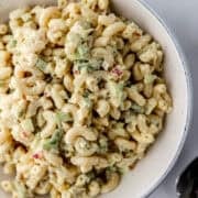 Close up view of salad in a bowl by spoon.