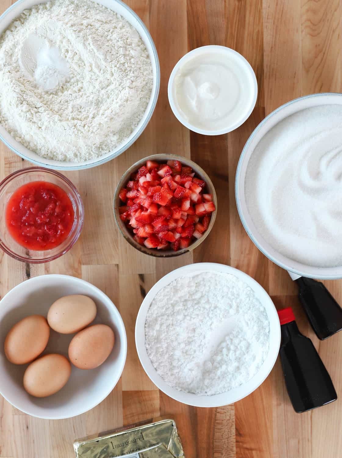 Overhead view of ingredients needed to make cake in separate bowls. 