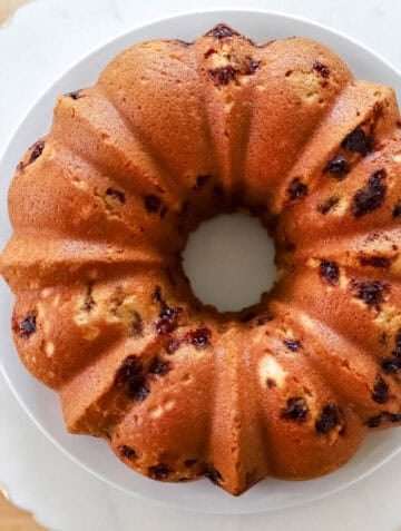 Overhead view of baked cake on white plate.