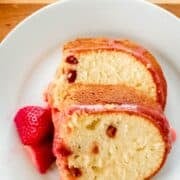 Overhead view of two slices of cake on white plate on pin with text overlay.