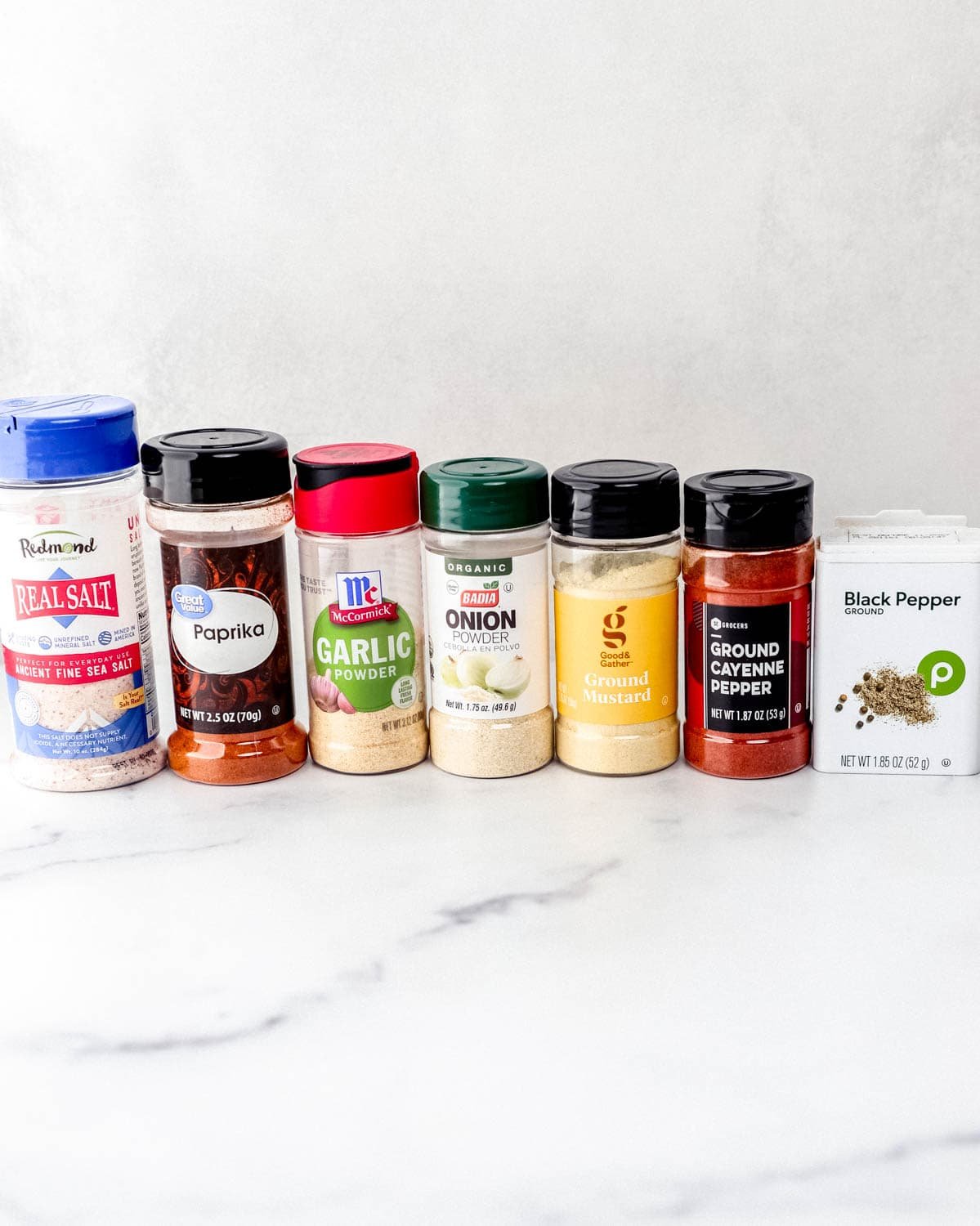 Close up side view of spices on marble surface.