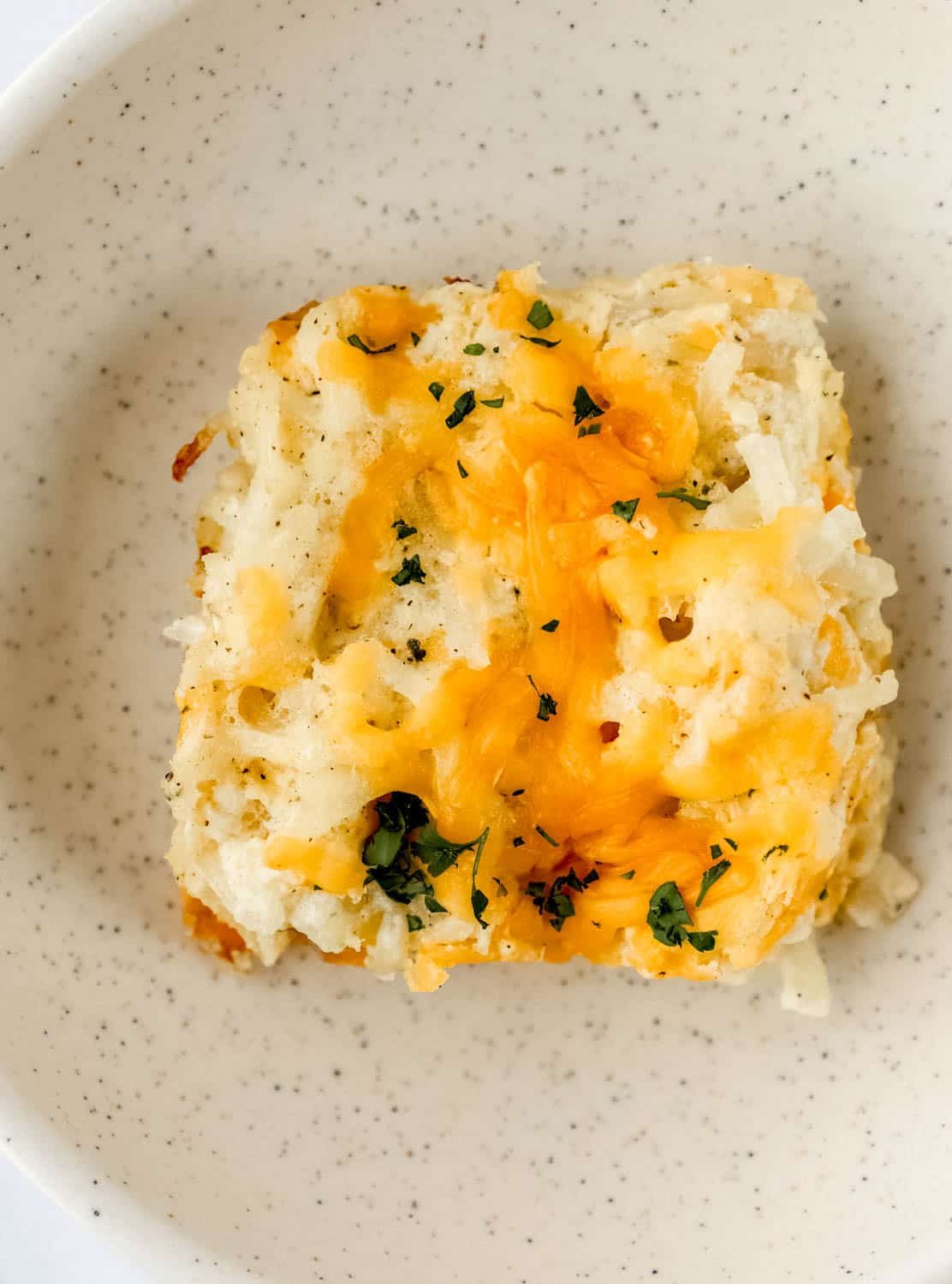 Overhead view of single serving of casserole in a bowl.