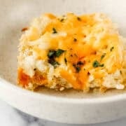 Close up side view of piece of casserole in bowl.