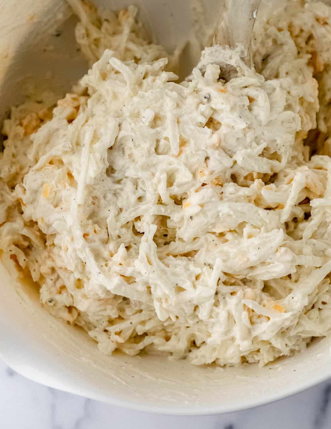 Ingredients mixed together in a large white mixing bowl.