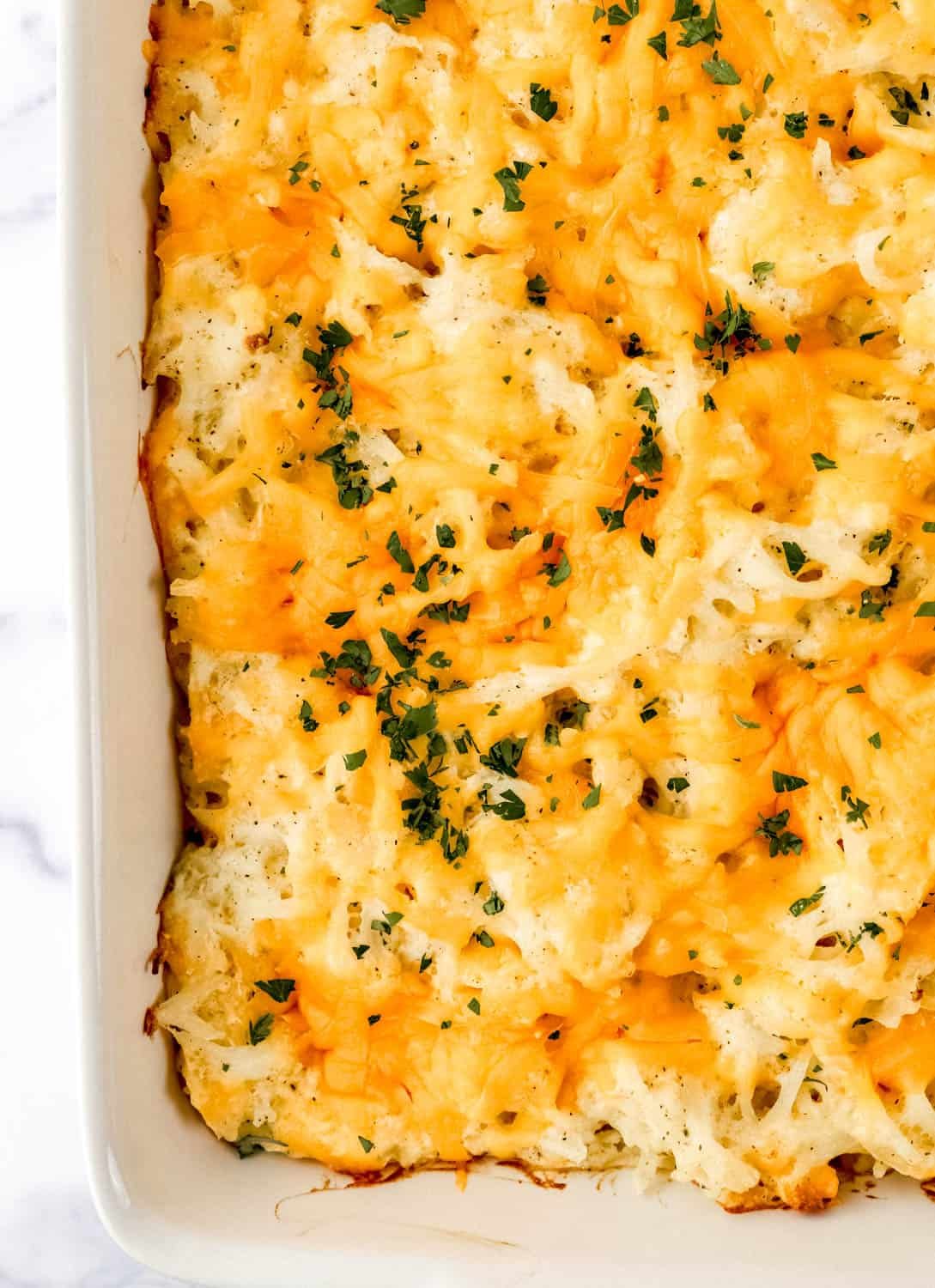 Overhead view of finished casserole in white baking dish.