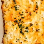 Overhead view of casserole in baking dish on pin with text overlay.