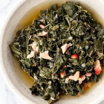 Close up overhead view of greens in a white bowl.