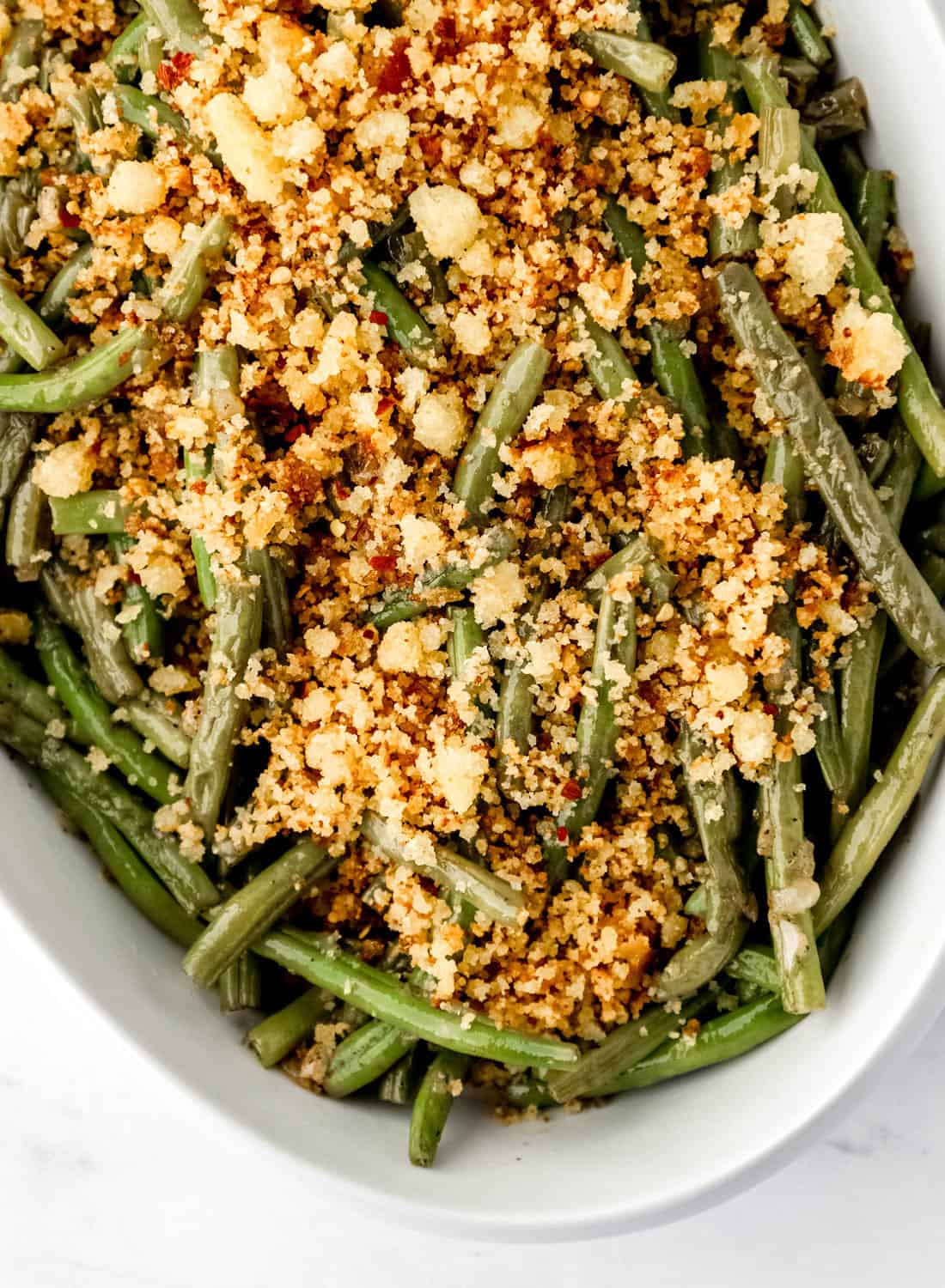 Close up view of finished beans topped with cornbread crumbles.