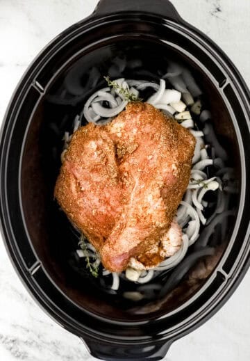 Turkey added to slow cooker on top of other ingredients.