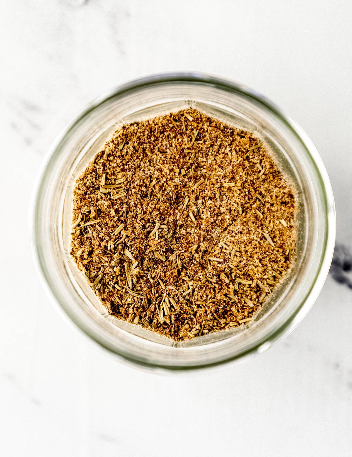 Overhead view of seasoning in glass jar. 