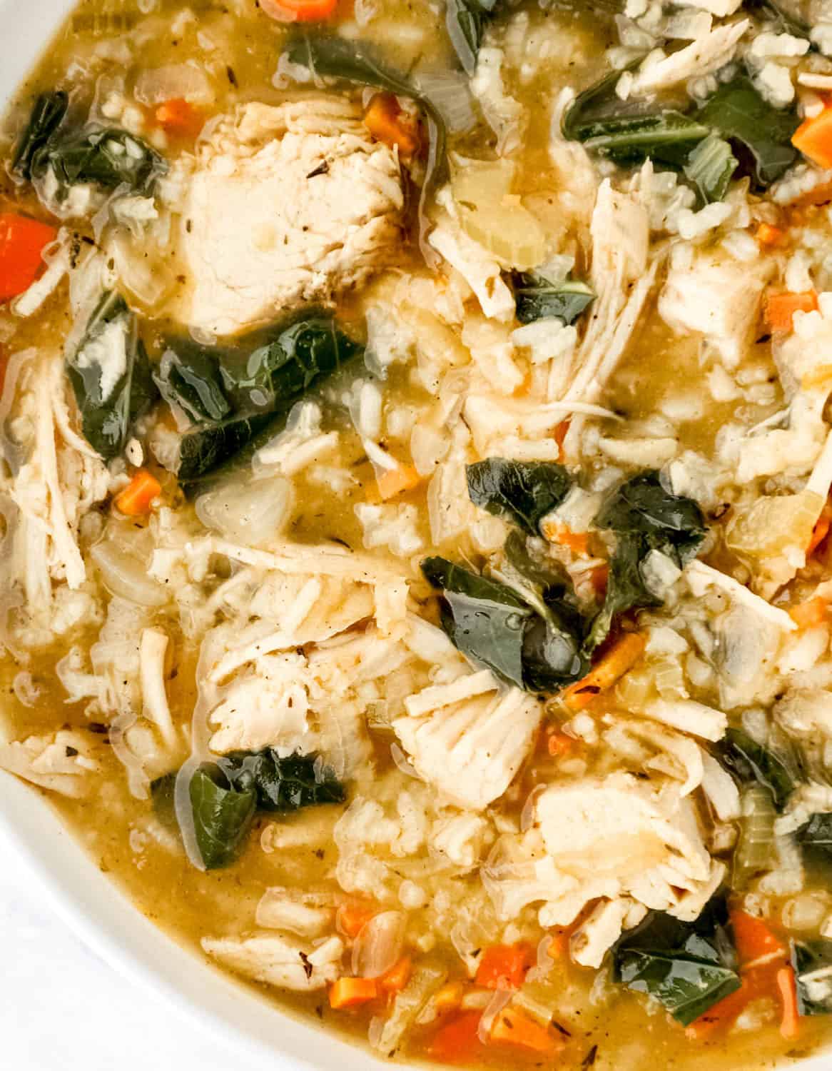 Close up view of soup in a large white bowl.