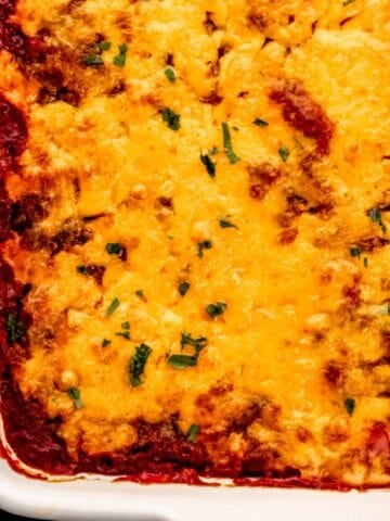 Close up view of finished sloppy joe casserole in white baking dish.