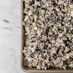 Overhead view of finished popcorn on parchment lined sheet pan.