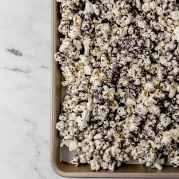 Overhead view of finished popcorn on parchment lined sheet pan.