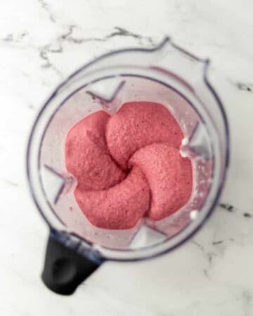 Overhead view of ingredients blended in blender.