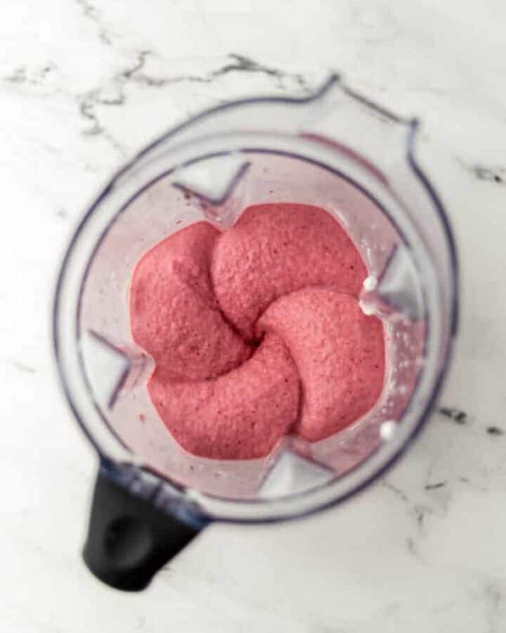 Overhead view of shake ingredients in a blender pitcher.