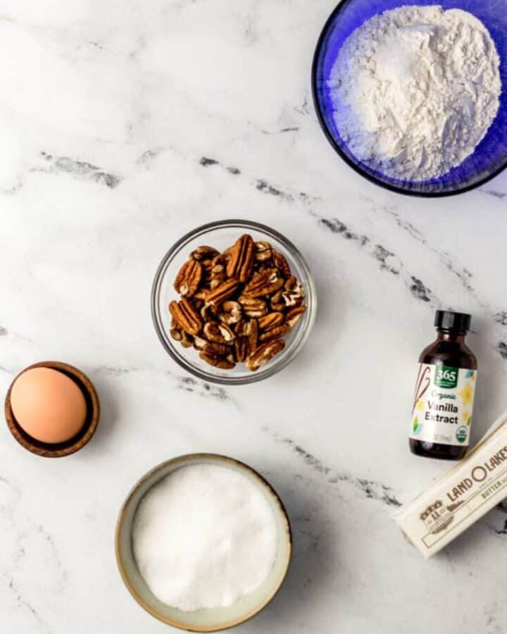 Ingredients needed to make cookies in separate bowls.